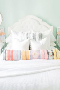 Provide guests with an assortment of pillows to help them sleep well. Image: Glitter Guide